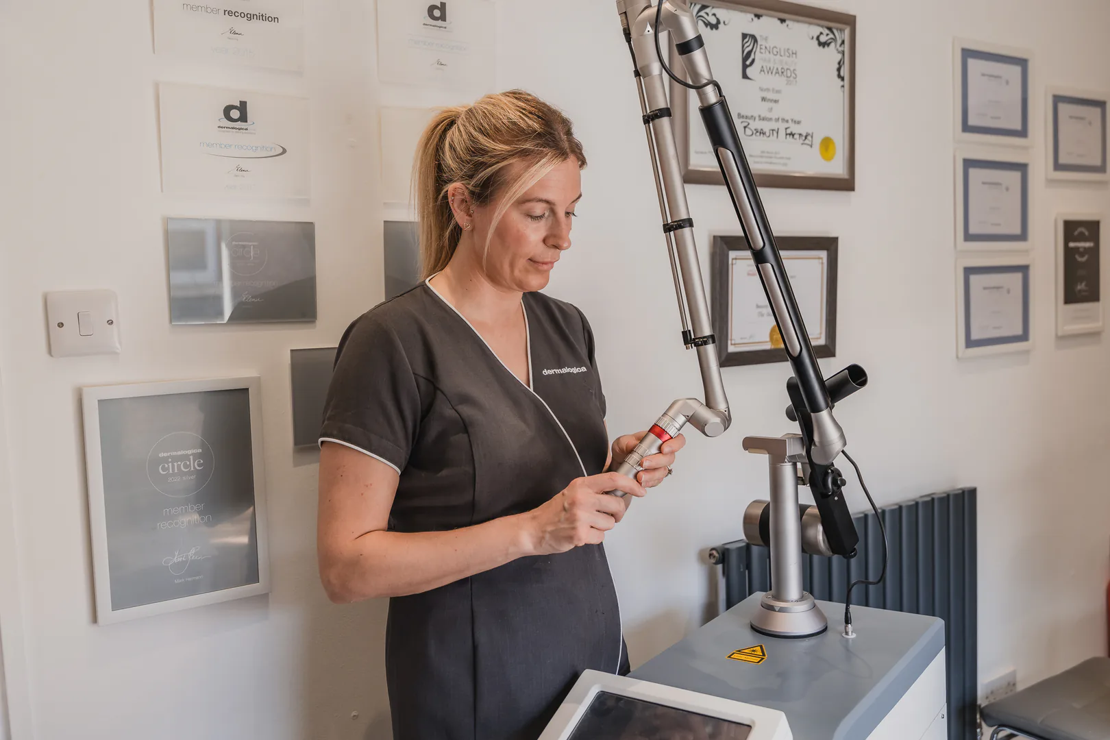 Beauty therapist preparing professional laser equipment at The Beauty Factory